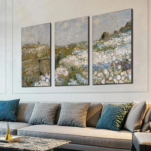Impressionist triptych painting set of 3 wildflower fields with white and blue flowers on a sofa wall.