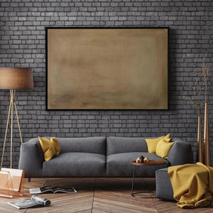 Earthy Minimalist Landscape painting by Liam O'Connell above gray sofa, modern living room decor.