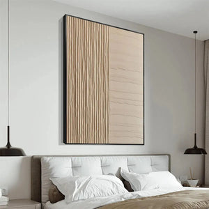 Textured beige minimalist painting by Javier Ramirez with vertical and horizontal lines, framed, above bed.