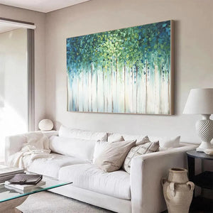 Large Emerald Forest abstract painting in green & blue, enhancing a modern living room with white sofa.