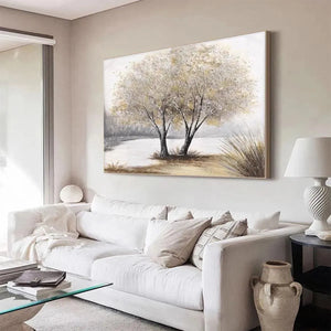 Liam O'Connell's 'Twilight Trees' landscape painting above a white sectional sofa, adding serene modern decor.