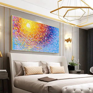SUNRISE SERENADE abstract painting by Willow Davies. Yellow, orange, pink, and blue sunrise art, framed, over bed.