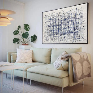 BLUE WEAVE abstract art by Javier Ramirez, blue and white textured painting above green couch in modern living room.