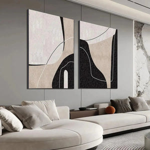 Two vertical abstract paintings with beige, black, white organic shapes and thin lines in a modern living room setting.