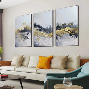 Gold & Grey Abstract Triptych: 3 vertical paintings with impasto texture, displayed above a modern white sofa.
