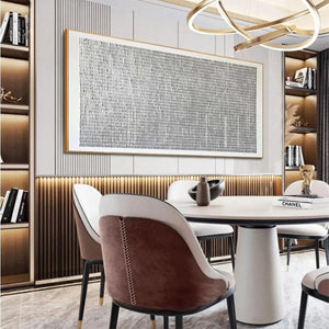 WOVEN TEXTURE painting, minimalist grey & white grid art by Javier Ramirez in gold frame, shown in a modern dining room.