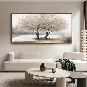 Serene 'Twilight Trees' landscape painting displayed above a cream sofa in a modern living room.