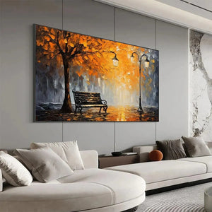 Impressionistic Autumn Park Bench painting, warm orange & grey tones, displayed over a contemporary living room sectional.