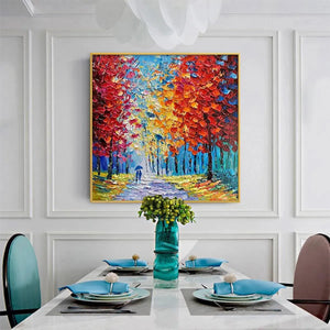 Textured impasto 'Autumn Walk' painting with vibrant red, orange, yellow trees and couple, in modern white dining room.