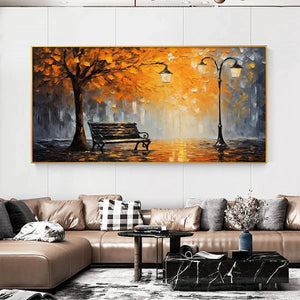 Horizontal Autumn Park Bench impressionistic artwork, orange & grey, in a gold frame above a contemporary living room sofa.