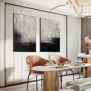 Liam O'Connell's black and white abstract diptych. Modern art above a dining table with seating and elegant decor.