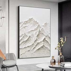Textured white impasto mountain painting by Liam O'Connell in black frame, modern living room decor.