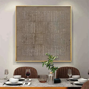 Minimalist textured brown grid painting by Javier Ramirez in a dining room setting, modern wall art.