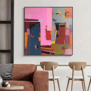 Pink and Green Urban Abstract square painting with impasto texture displayed above a sofa in a modern living room.