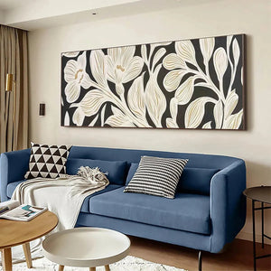 Golden Floral Panoramic wall art, cream flowers & gold accents on black, above blue sofa.