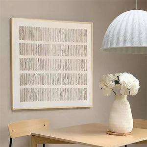 Minimalist textured beige wall art with vertical lines in light wood frame, styled in modern interior setting.