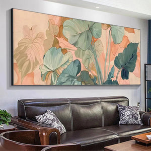Panoramic botanical painting with teal, sage green, and peach tropical leaves above dark leather sofa.