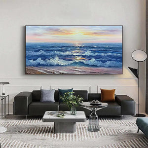 Golden Sunset Serenade ocean painting displayed above a gray sofa in a contemporary living space.