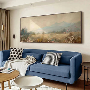 Meadow Valley Panoramic oil painting by Liam O'Connell, displayed above a blue sofa in a living room.