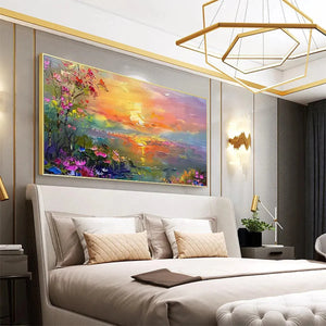 Impressionistic watercolor sunset landscape with vibrant flowers in gold frame, gracing a modern bedroom interior.