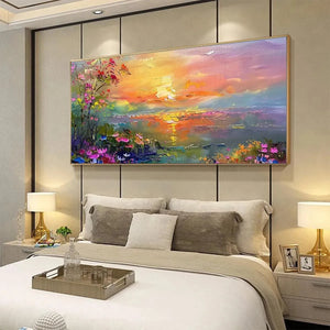Textured watercolor sunset painting with vibrant flowers, glowing water, and golden frame, in a modern bedroom.