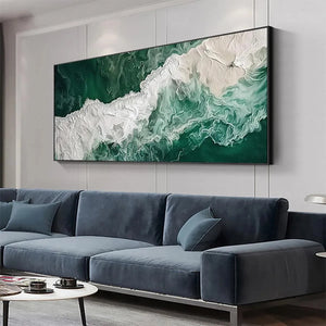 Emerald Flow abstract ocean painting, green & white, above blue sectional in modern living room.