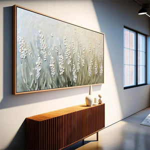 Textured Meadow floral landscape painting, green & white, natural wood frame, in modern interior above slatted console.