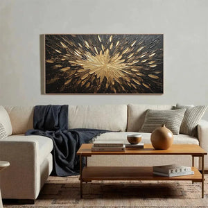Textured abstract painting Golden Burst with impasto gold sunburst on black, shown in modern living room lifestyle setting.