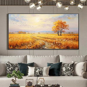 Golden Harvest landscape art featuring a field at sunset, autumn tree & birds, adorning a modern grey living room sofa.