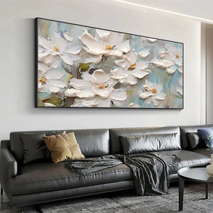 Panoramic textured painting of white magnolia blossoms, impressionist style, displayed above a modern sofa.