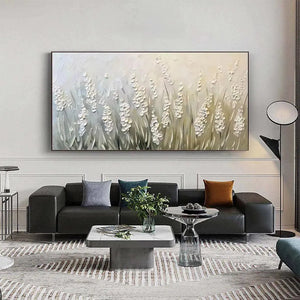 Textured white floral impasto painting on panoramic canvas, displayed above a dark gray sofa in a modern living room.