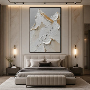 Textured impasto mountain ascent wall art with white, beige and gold peaks above a modern bed