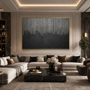 Textured black and grey abstract wall art in gold frame above luxury sofa