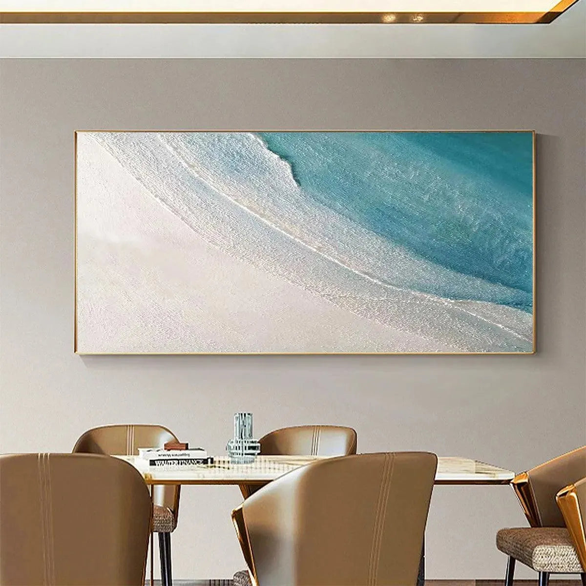 Liam O'Connell textured blue and white abstract beach painting, gold frame, above dining table.
