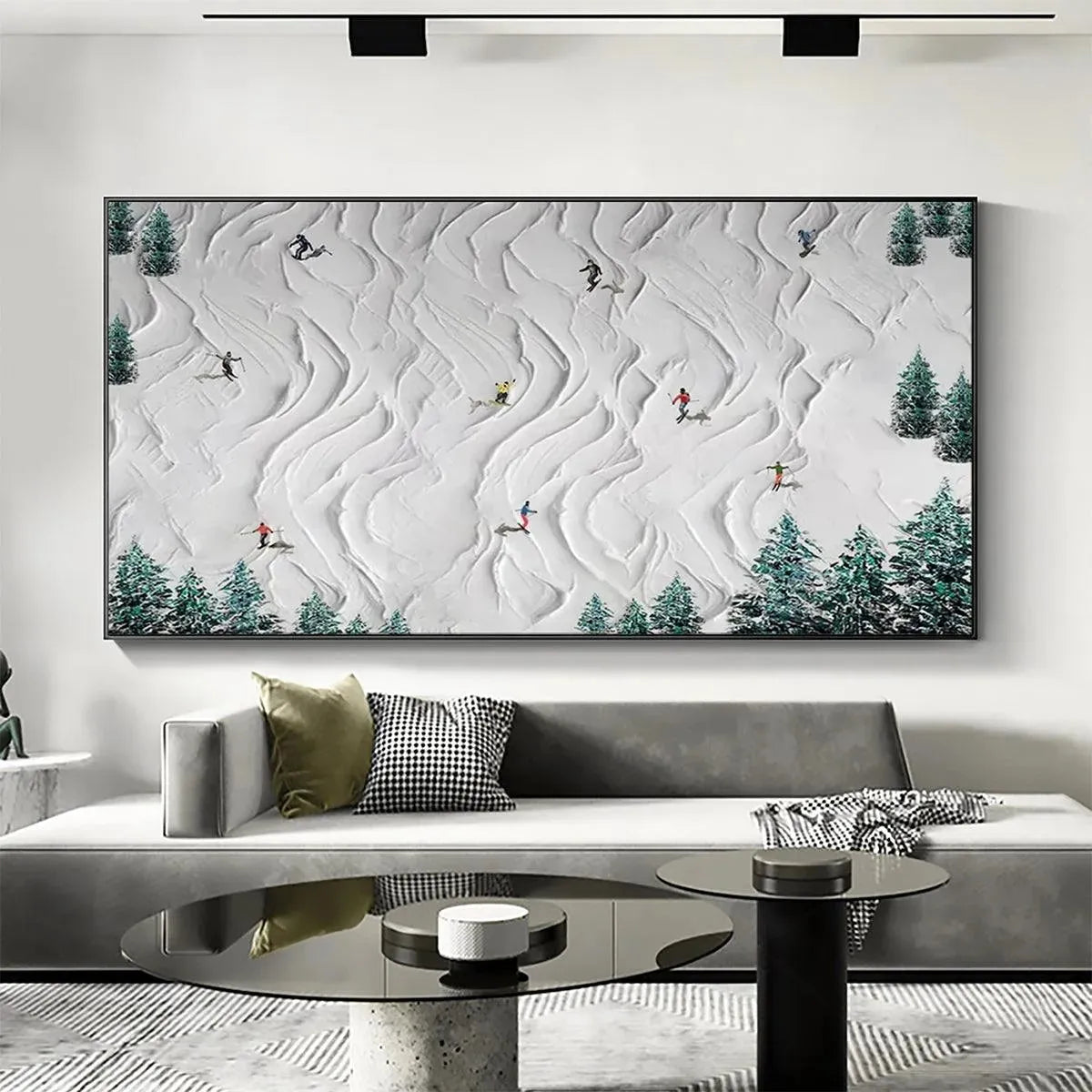 Textured panoramic winter sports painting with skiers and snowboarders on a snowy slope, above a sofa.
