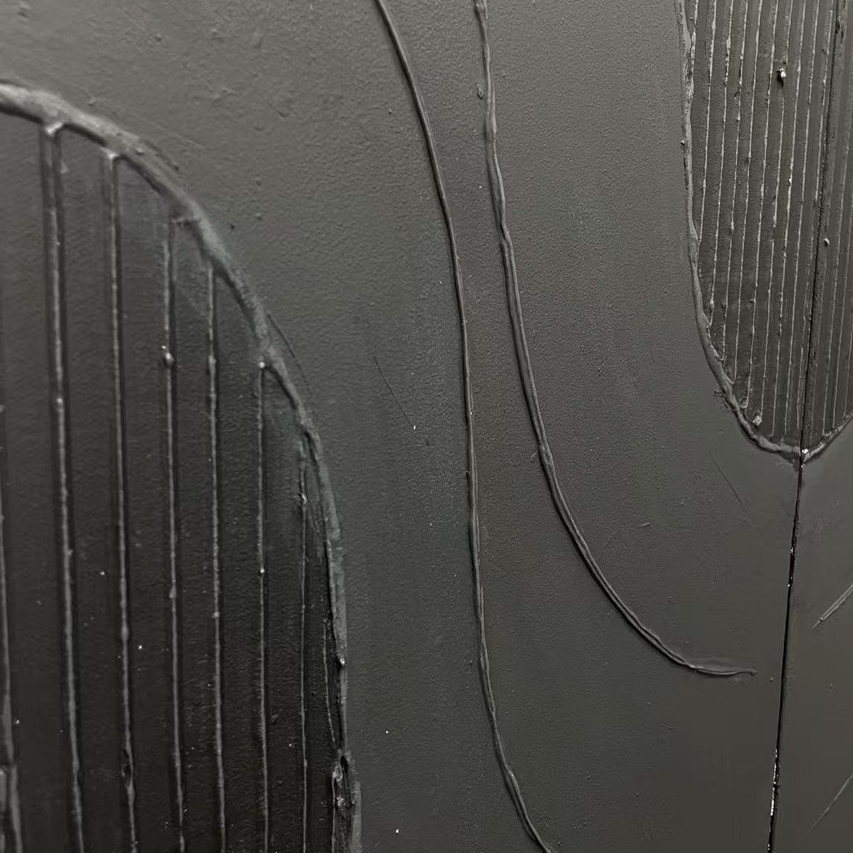 BLACK TEXTURED WAVES DIPTYCH: Close-up of abstract matte black textured wall art with raised wave patterns.