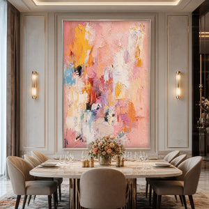 Vertical pink abstract oil painting with impasto texture and blush, yellow, orange accents in modern dining room