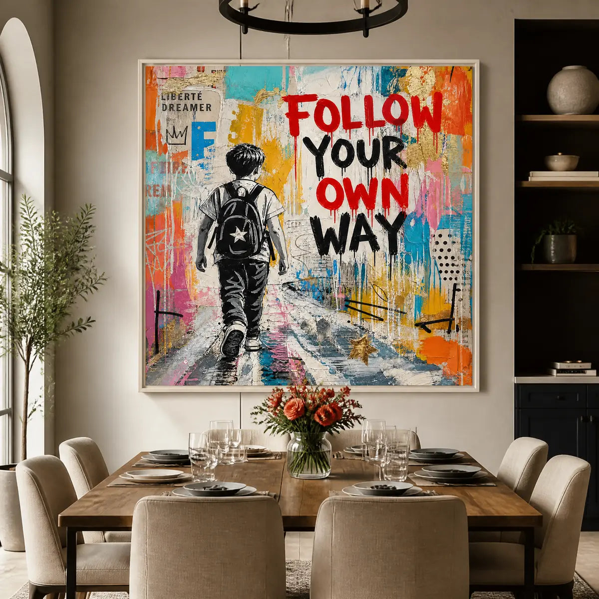 Colorful urban pop art painting with boy and bold text ‘FOLLOW YOUR OWN WAY’ displayed in a refined dining room.