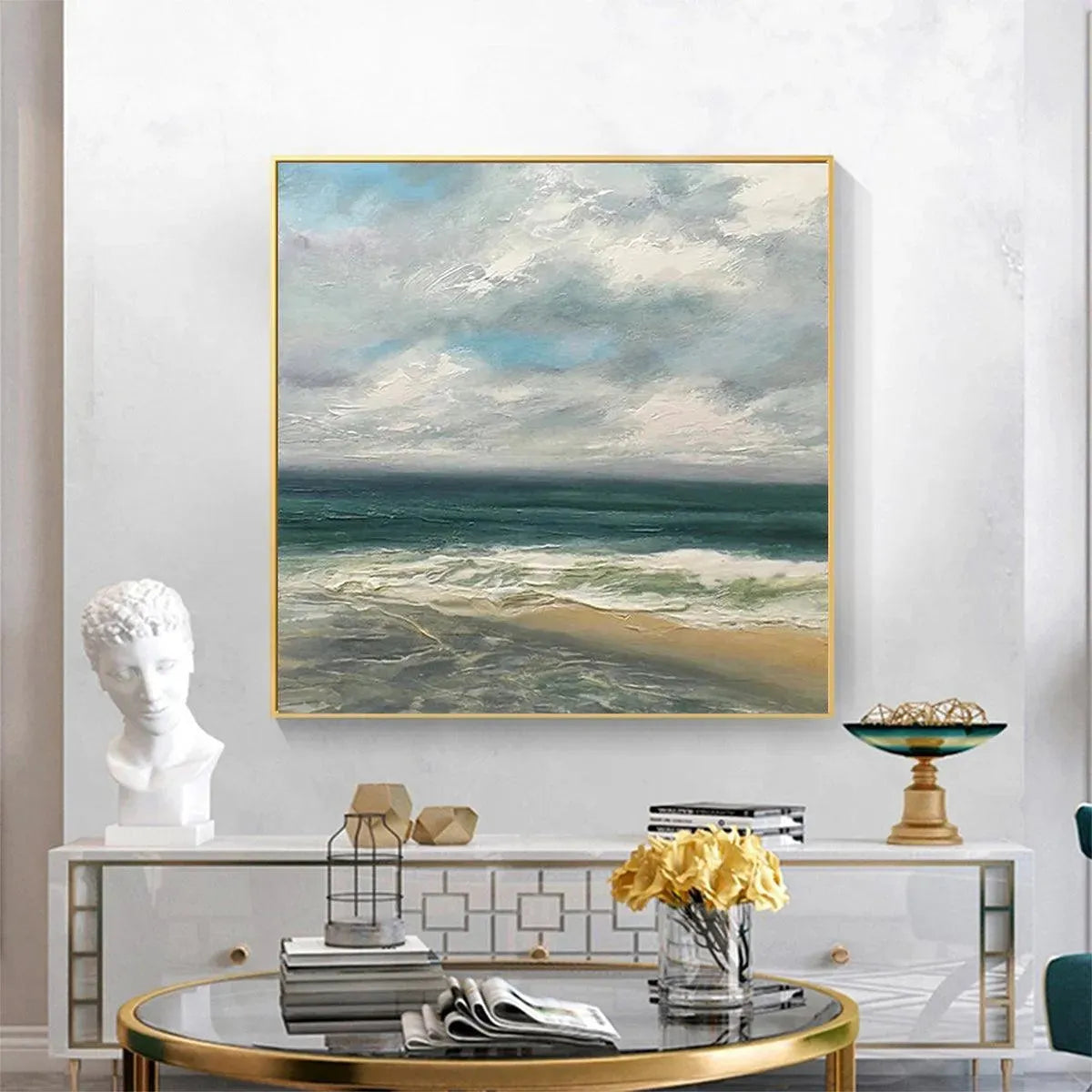 Square coastal landscape painting with textured waves, cloudy sky in teal and grey tones, framed in gold.