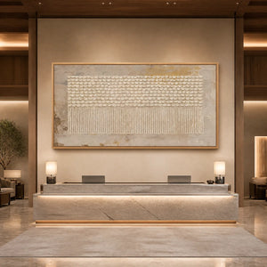 Neutral textured panoramic wall art with raised dot pattern in a wood frame displayed in a luxury hotel lobby.