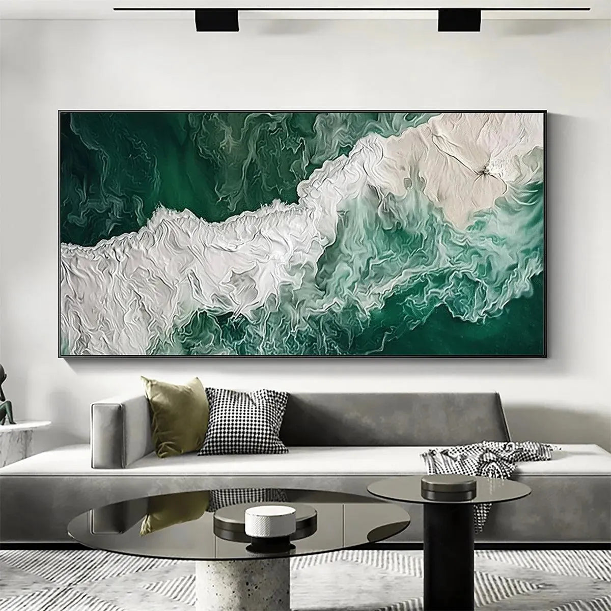 EMERALD FLOW: Textured emerald green & white impasto ocean art, horizontal, displayed above a modern grey sofa.
