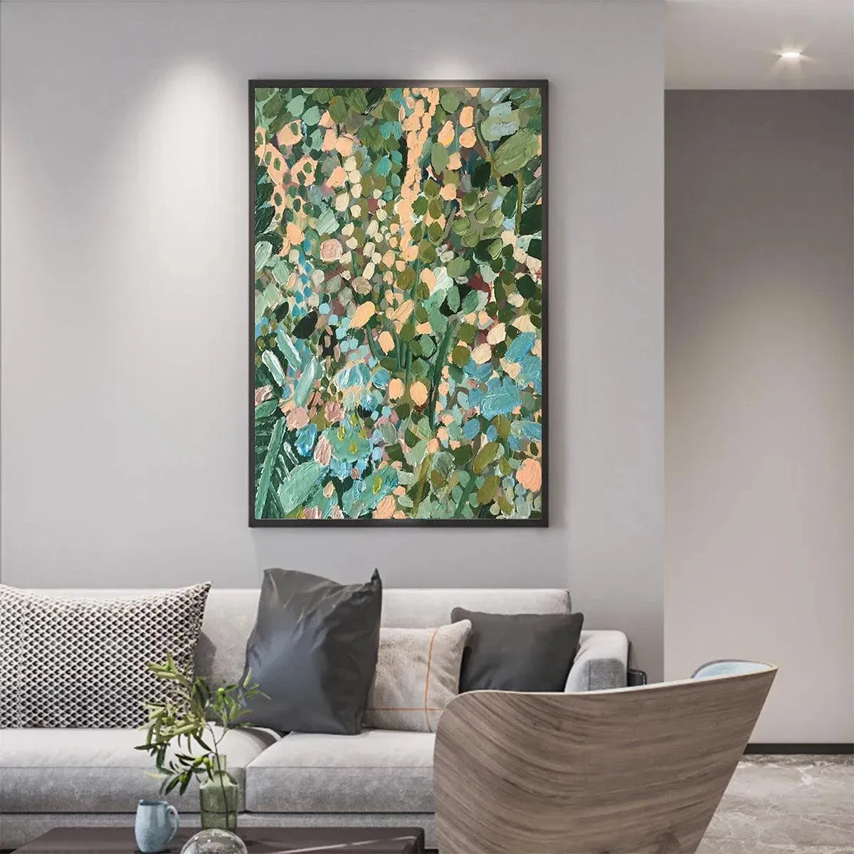 ENCHANTED GARDEN painting by Elodie Dubois: Abstract floral art with green, blue, peach hues, framed, above a gray sofa.