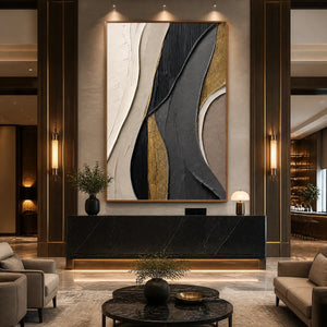 Gold and black geometric abstract wall art in a wood frame displayed in a luxury hotel lobby.