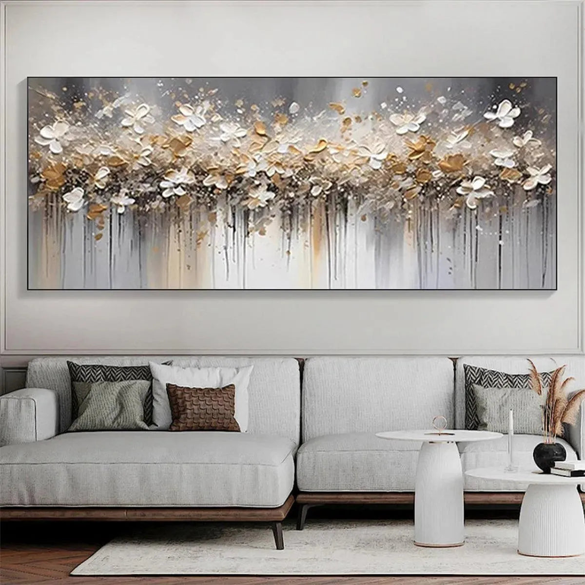 GOLDEN DRIFT: White and gold abstract floral painting in a living room setting.