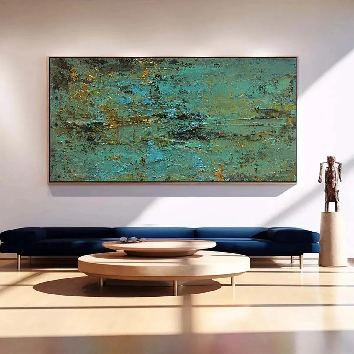 Golden Tide textured abstract art in teal and gold, framed horizontally over navy sofa in a modern living room.