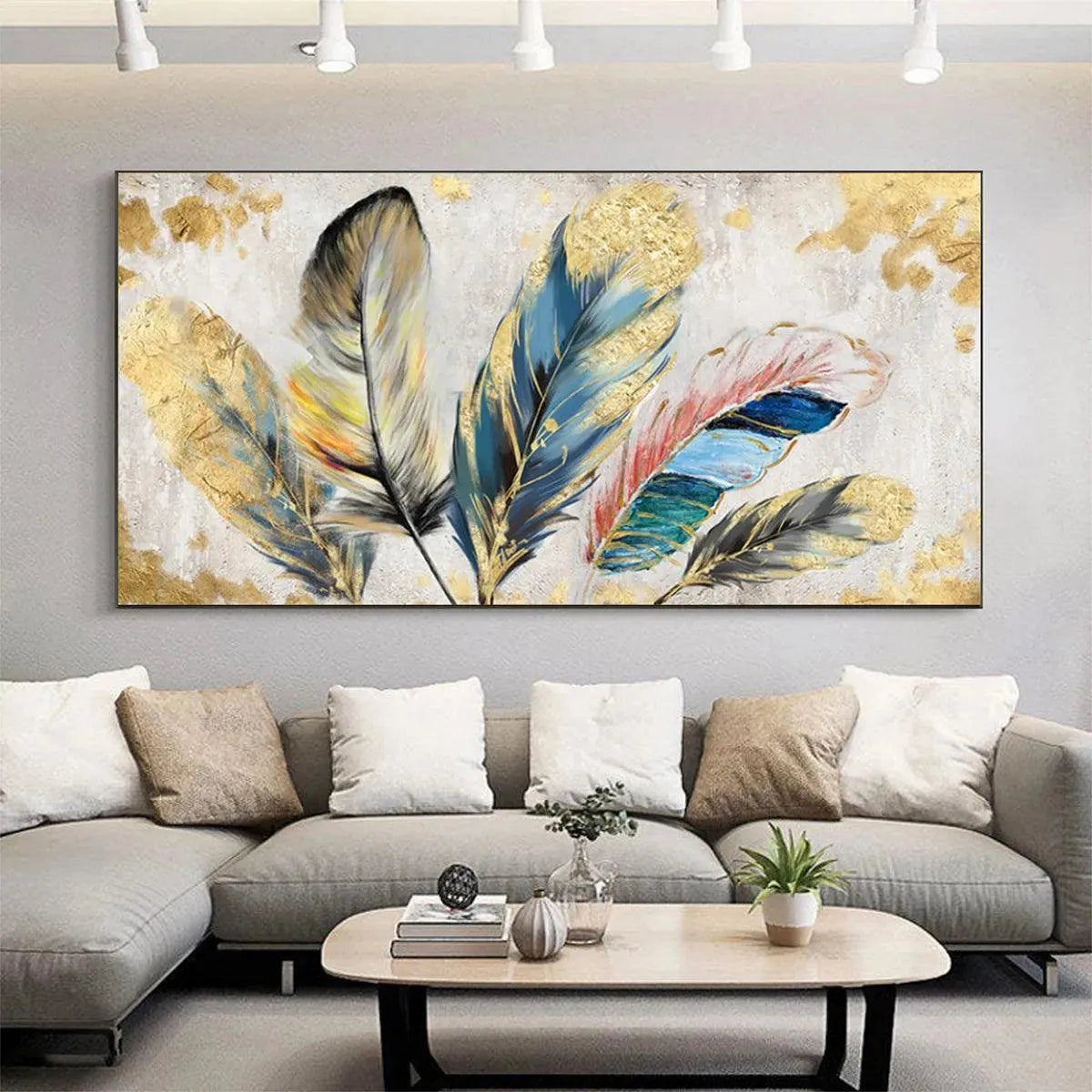 Panoramic gold and blue feather painting with gold leaf accents, displayed above a sofa in a living room.