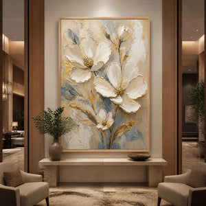 White magnolia floral wall art with gold accents displayed in a luxury hotel lobby.