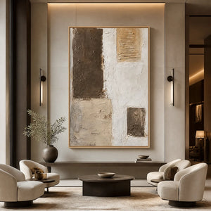 Neutral block texture abstract wall art in beige, ivory, and brown tones in a wood frame displayed in a luxury hotel lobby.