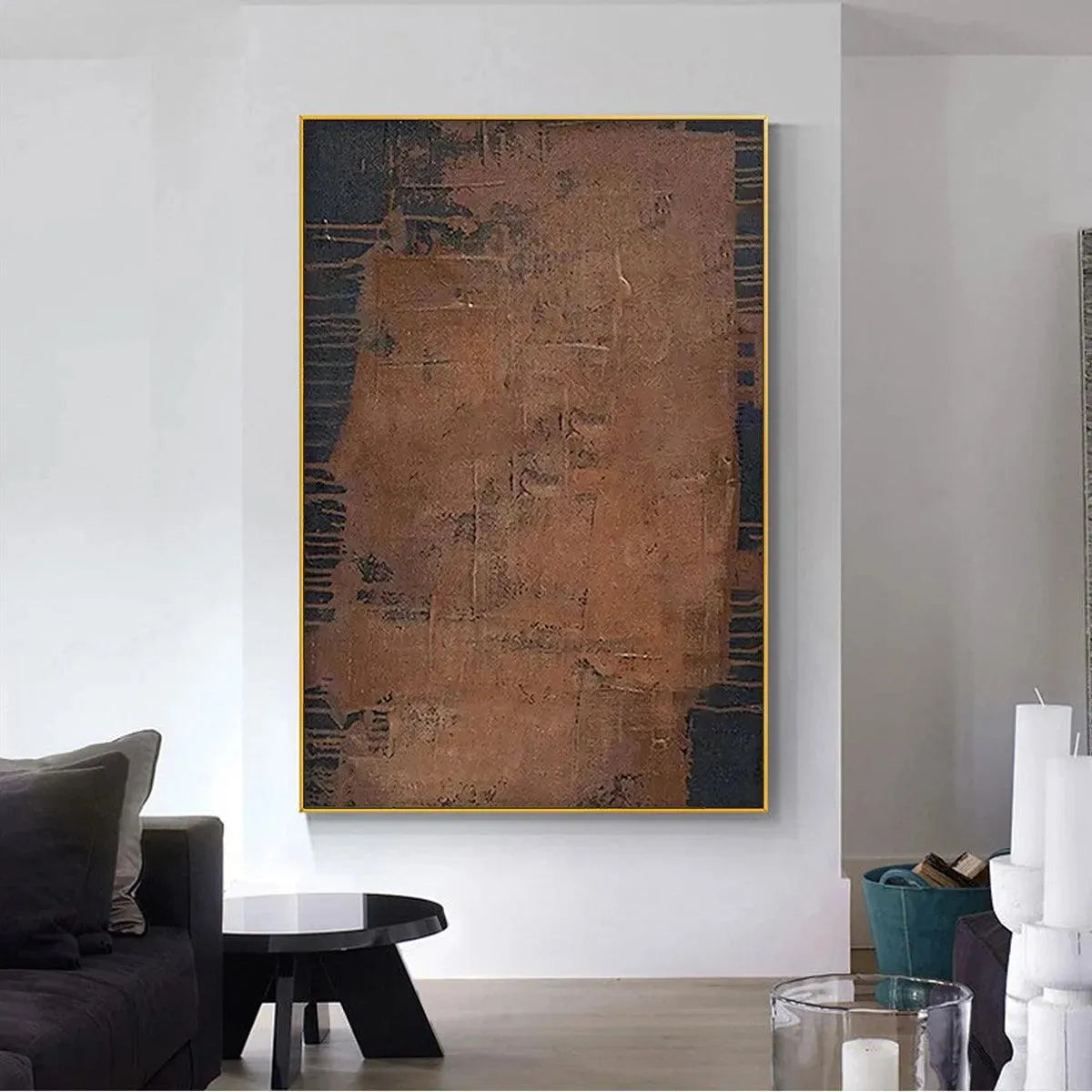 Textured abstract painting in brown and dark gray by Javier Ramirez, vertical artwork with gold frame in a modern living room