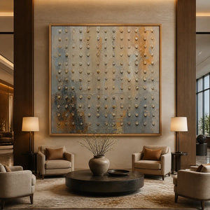 Textured abstract wall art with raised beaded details in a wood frame displayed in a luxury hotel lobby.